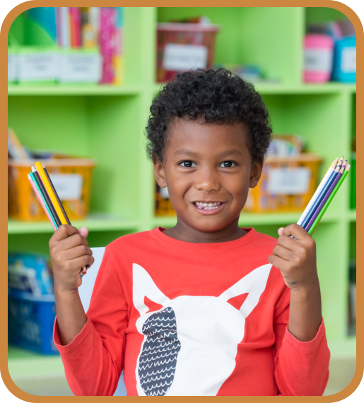 male kid holding his coloring pencils