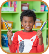 male kid holding his coloring pencils